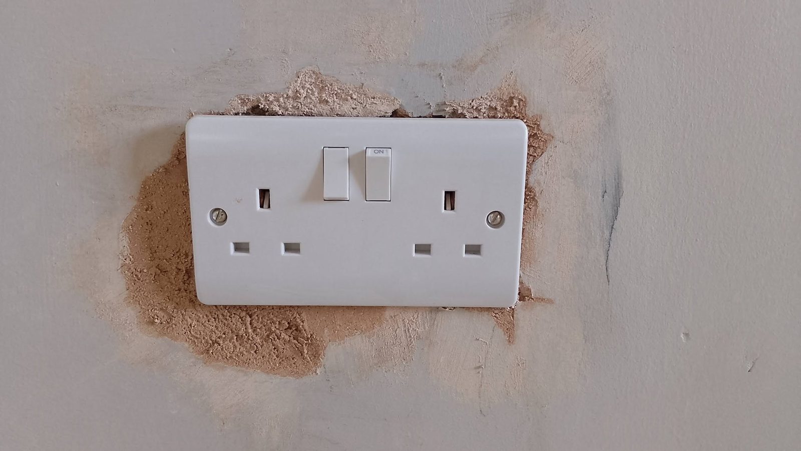Filler around a socket, sanded smooth